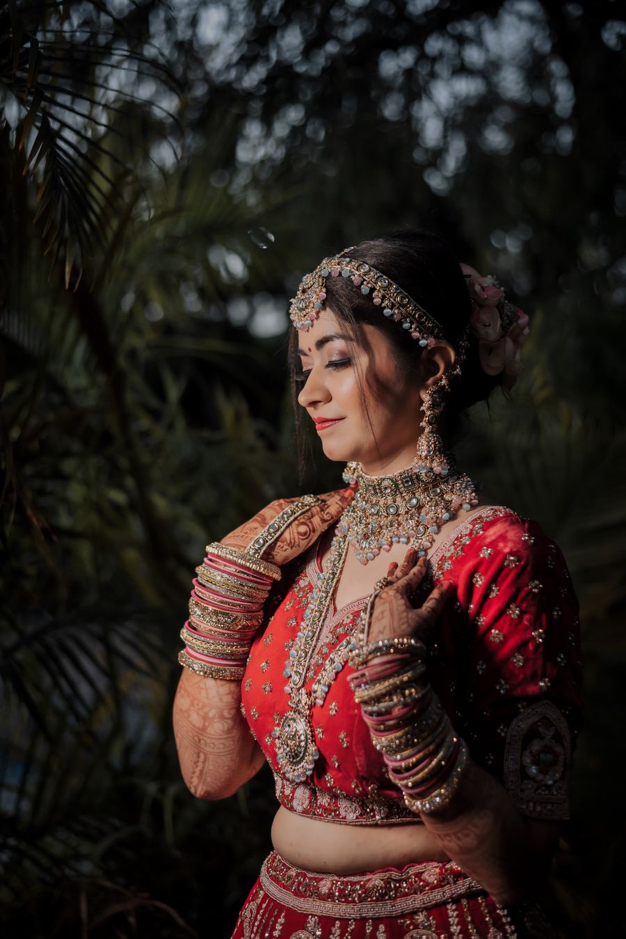 A bride in red against a dark background