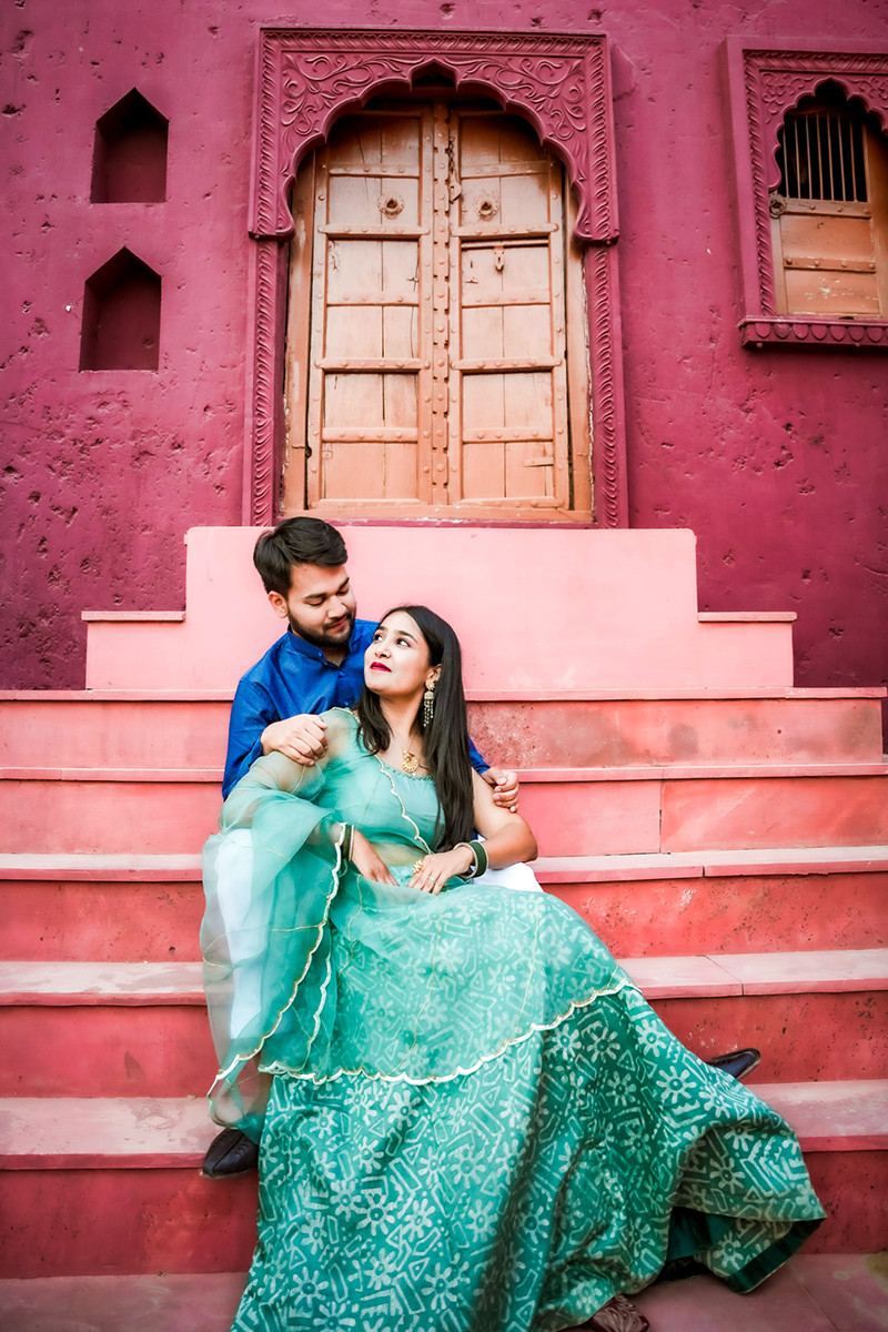 A couple on the pink haveli steps